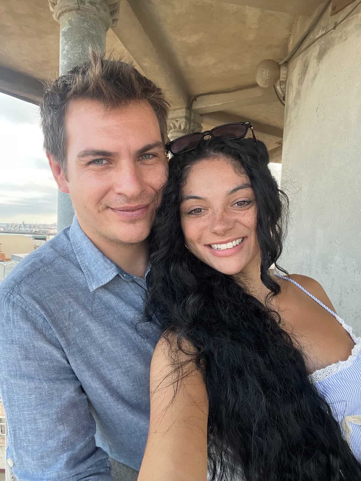 long distance relationship image of black curly haired female and short haired man in blue shirt