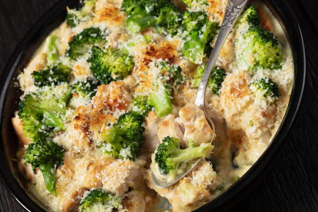 easy crock pot chicken divan in a black slow cooker