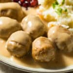 easy crock pot swedish meatballs on a white plate with sauce