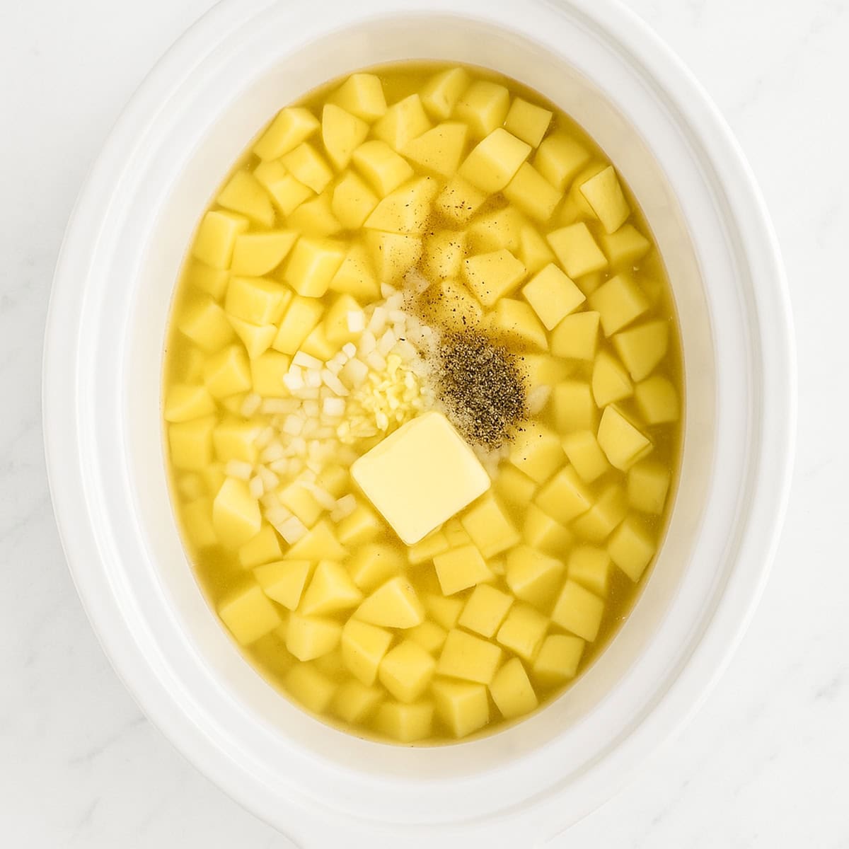 slow cooker baked potato soup ingredients in a pot