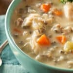 slow cooker chicken and wild rice soup with no cream in a blue bowl