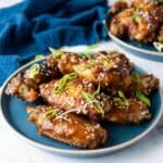 Asian Sticky Chicken Wings served on a blue plate