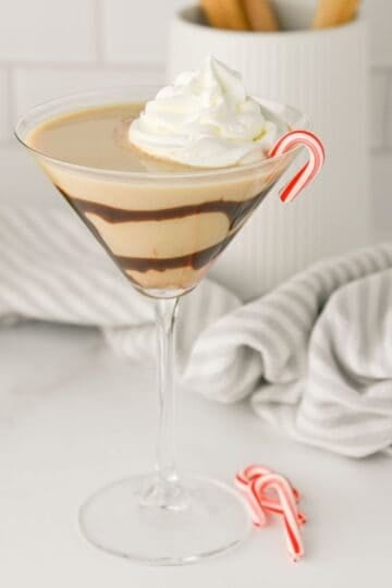 Baileys Peppermint Martini in a clear cocktail glass with a peppermint candy cane
