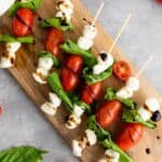 Easy Caprese Skewers laid out on a wooden board