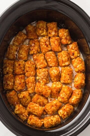 Easy Cowboy Casserole with tater tots on top in a crockpot