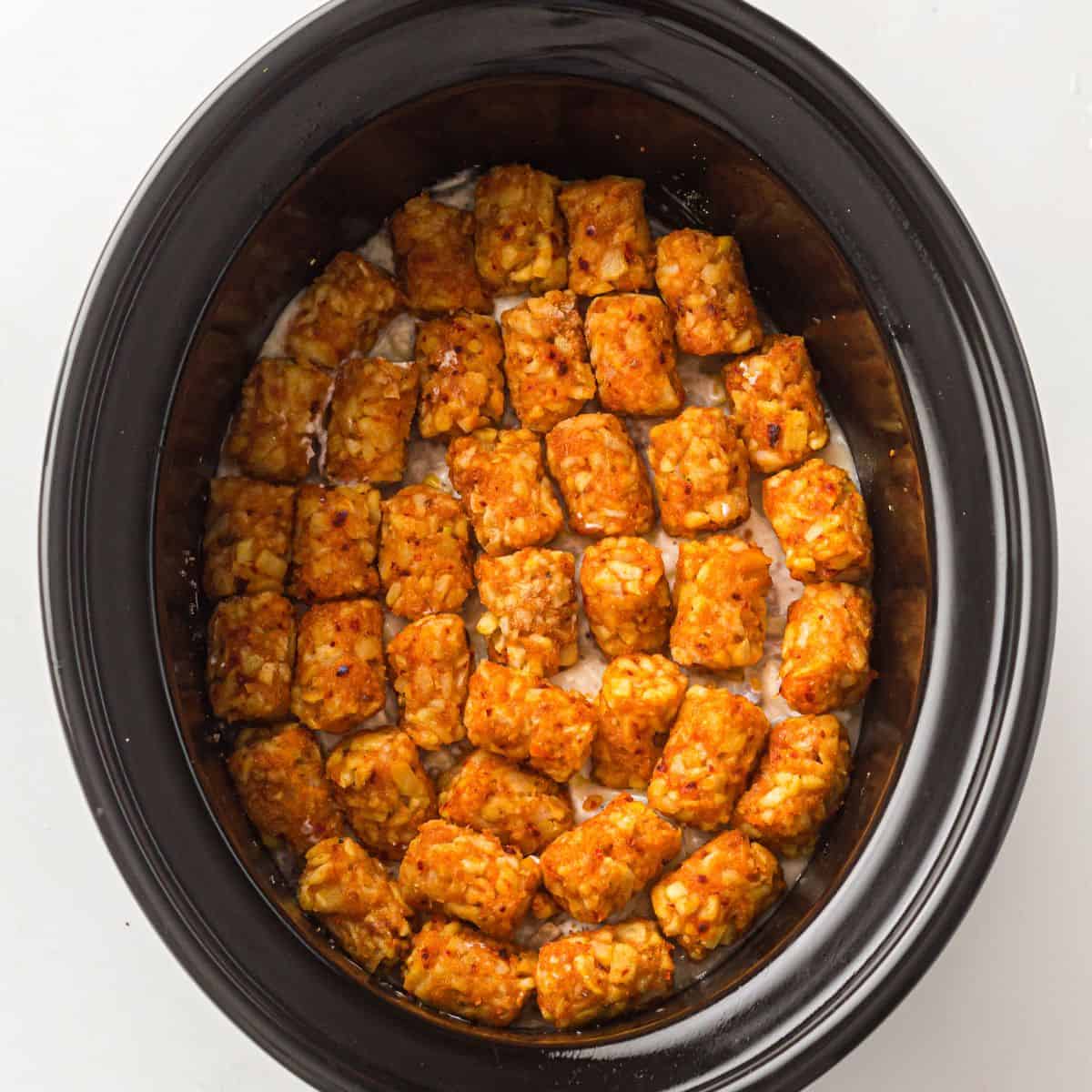 Easy Cowboy Casserole with tater tots on top in a crockpot