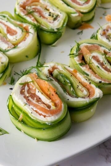 Everything Bagel Cucumber Rolls served on white plate sitting on the counter