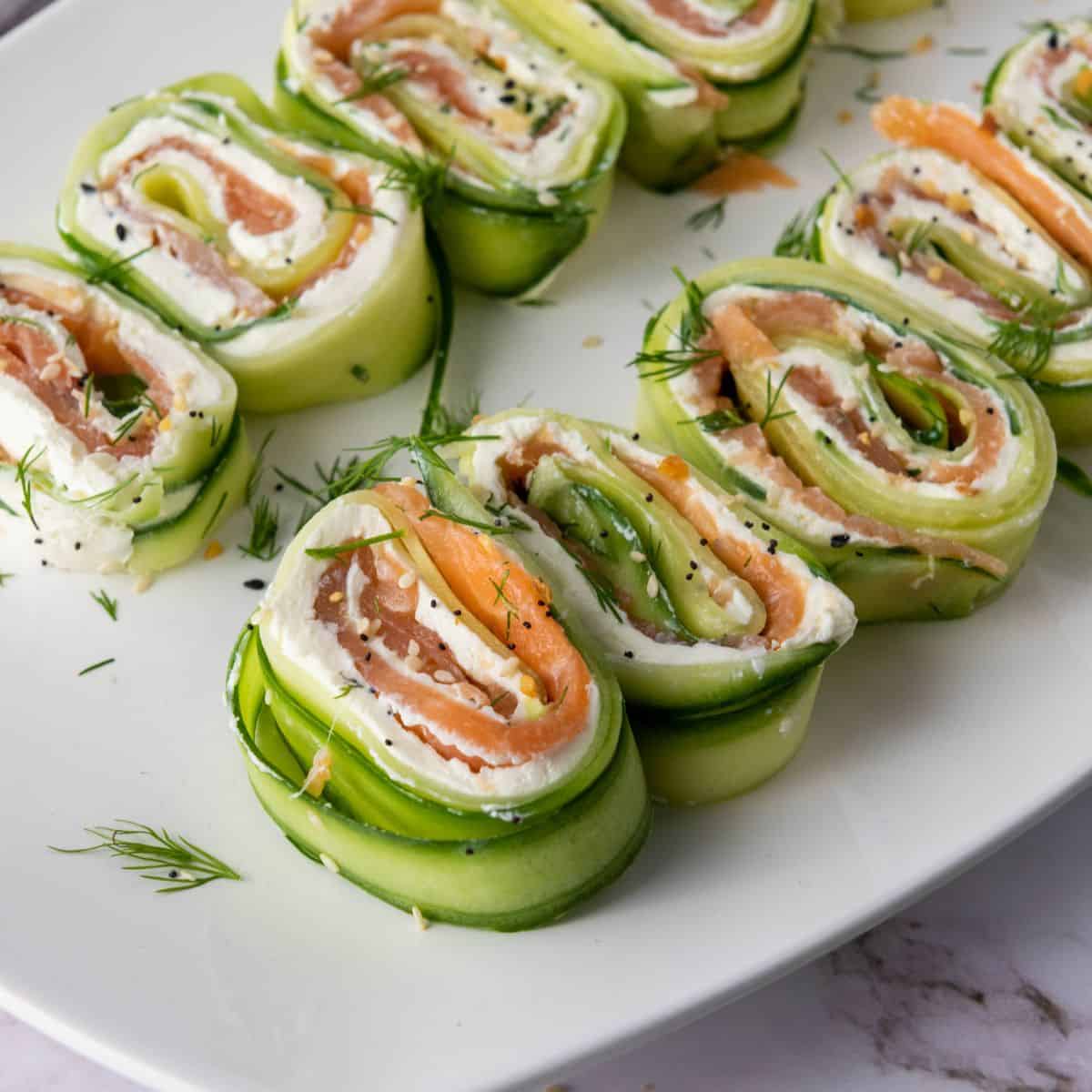 Everything Bagel Cucumber Rolls served on white plate sitting on the counter