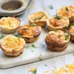 Mini Salmon Quiches being served on a marble counter