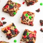 Santa's Cookie Bars cute into squares and topped with holiday cookies and M&Ms