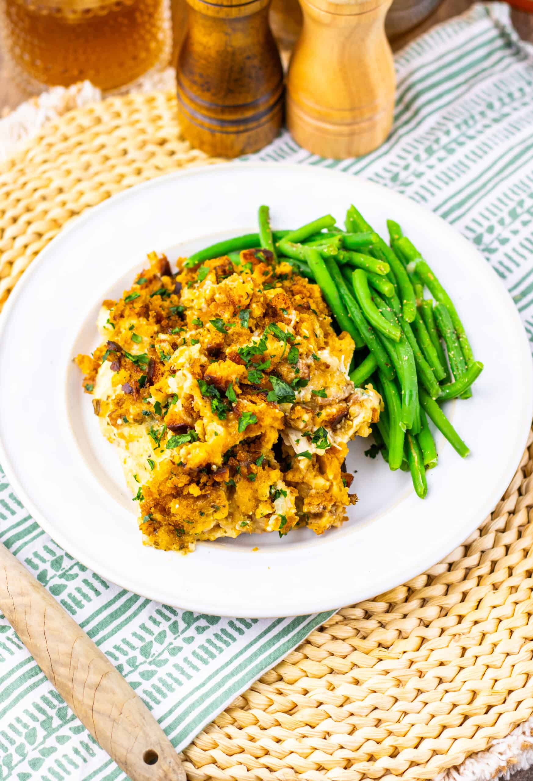 Slow Cooker Chicken and Stuffing next to green beans on a white plate