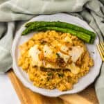 Slow Cooker French Onion Chicken and Rice served on a plate with asparagus
