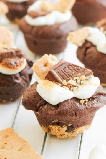 S’more Brownie Bites sitting on a white wooden table
