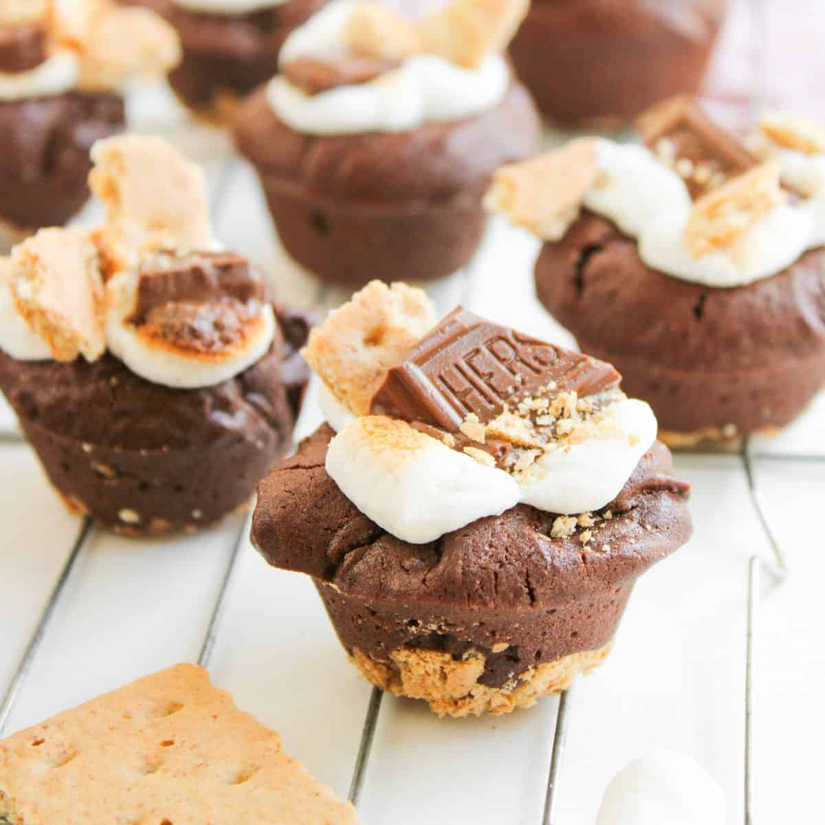 S'more Brownie Bites sitting on a white wooden table