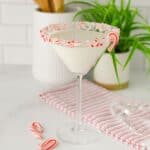 White Chocolate Peppermint Martini served in a clear glass with crushed candy canes on the rim