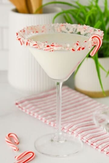 White Chocolate Peppermint Martini served in a clear glass with crushed candy canes on the rim