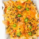 crockpot chicken nachos featured and served on a white plate