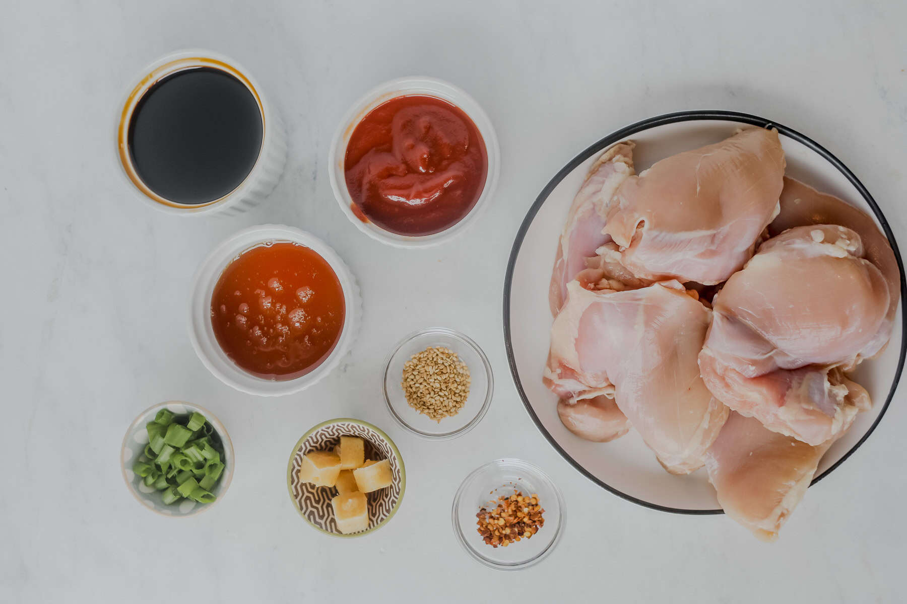 honey garlic chicken thighs ingredients on a white background