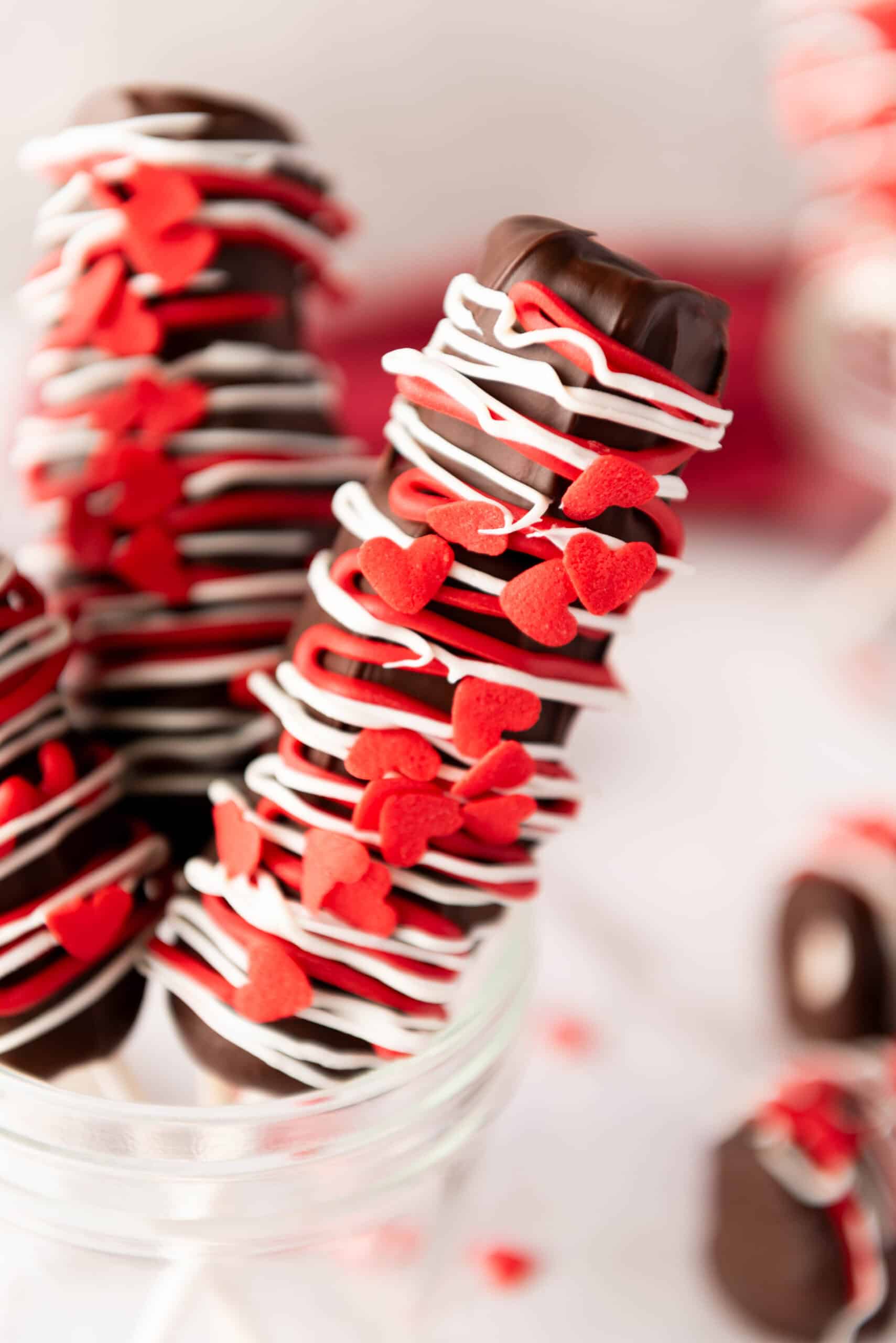 marshmallow pops with red and white sprinkles and decorative icing