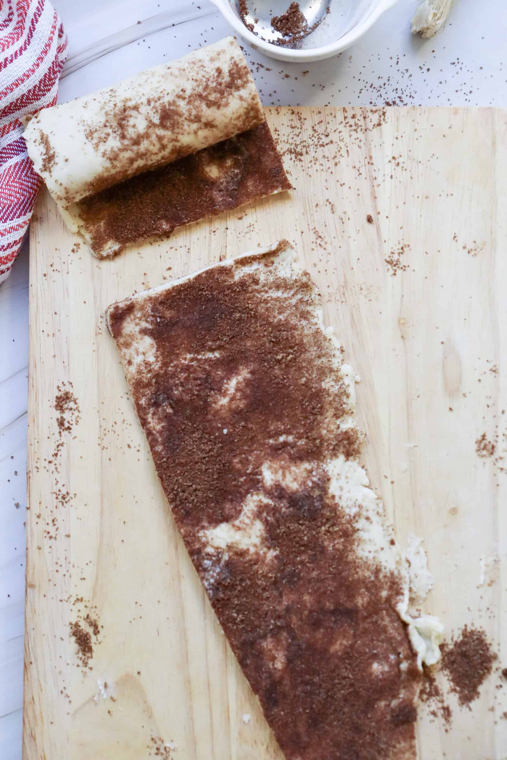 Dough rolled out with cinnamon and sugar and butter mixture on top
