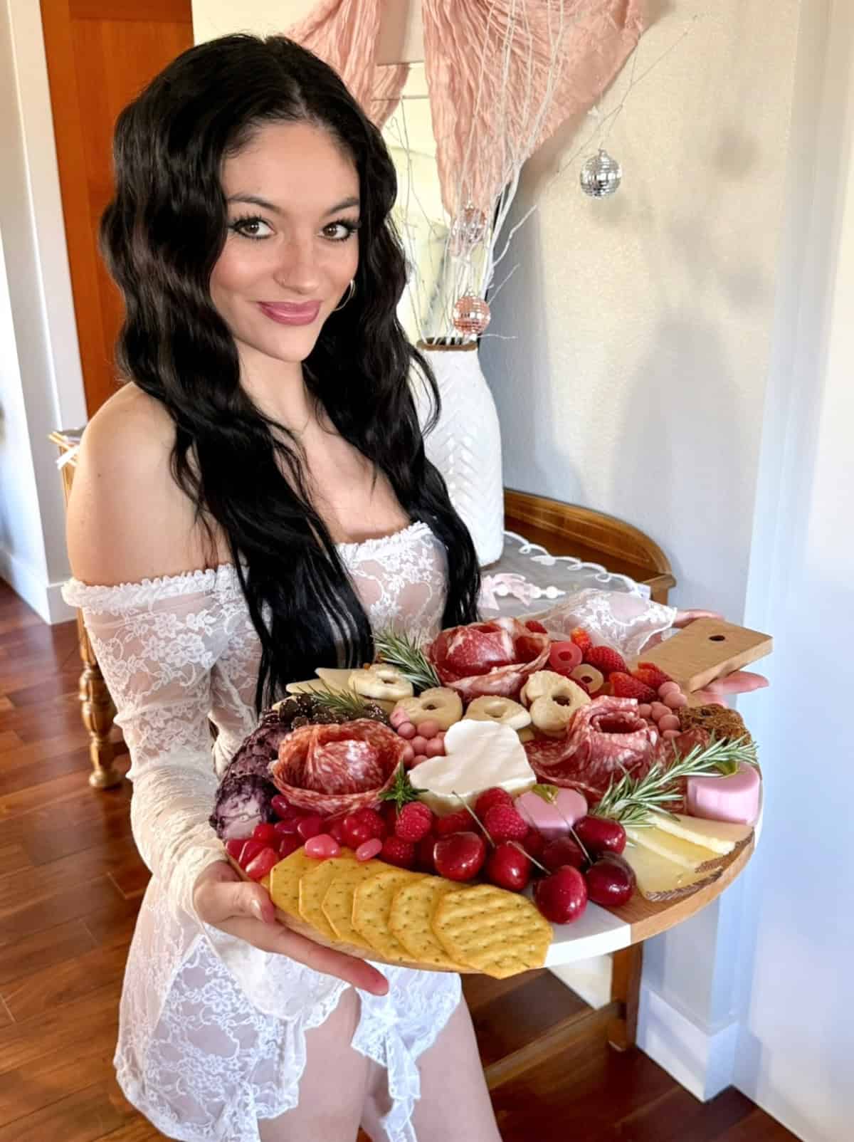 madi holding a galentines day charcuterie board