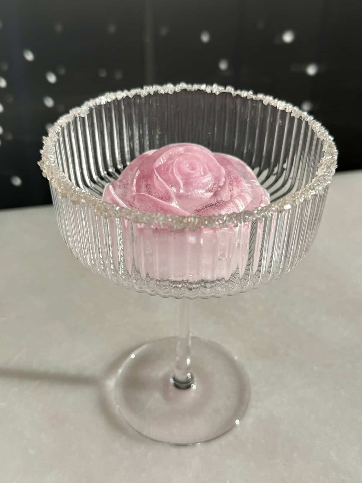 a rose ice cube with prosecco to make a Bridgerton cocktail