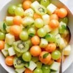 leprachaun fruit salad for st patricks day in a white bowl