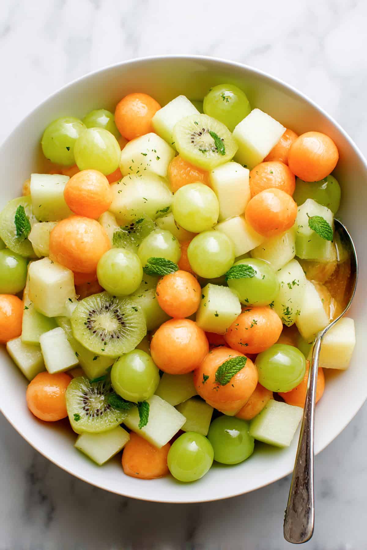 leprachaun fruit salad for st patricks day in a white bowl