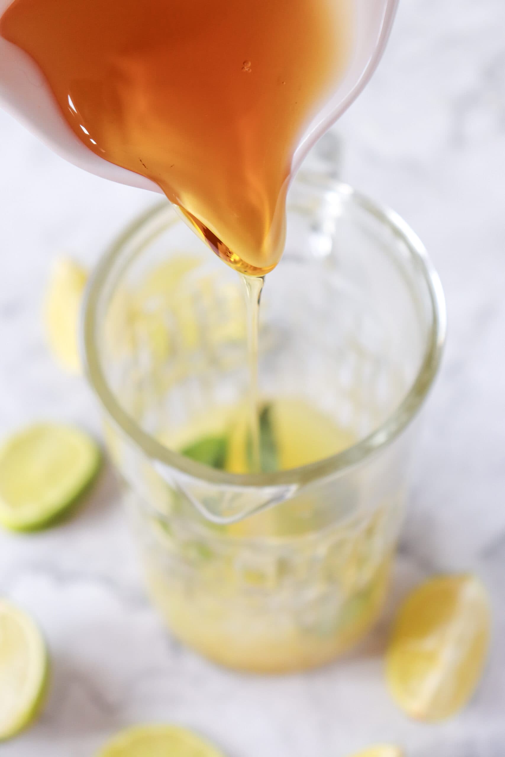 image of agave being poured into glass with lime juice