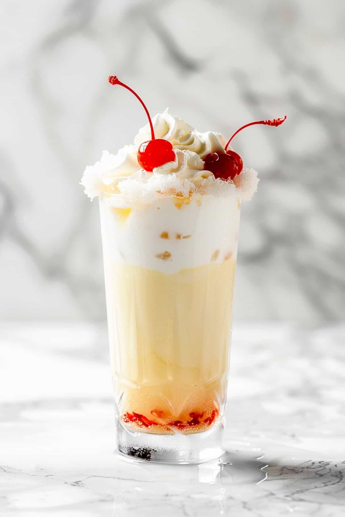 vanilla cream dirty soda with sprite with cherries as a garnish on a white background