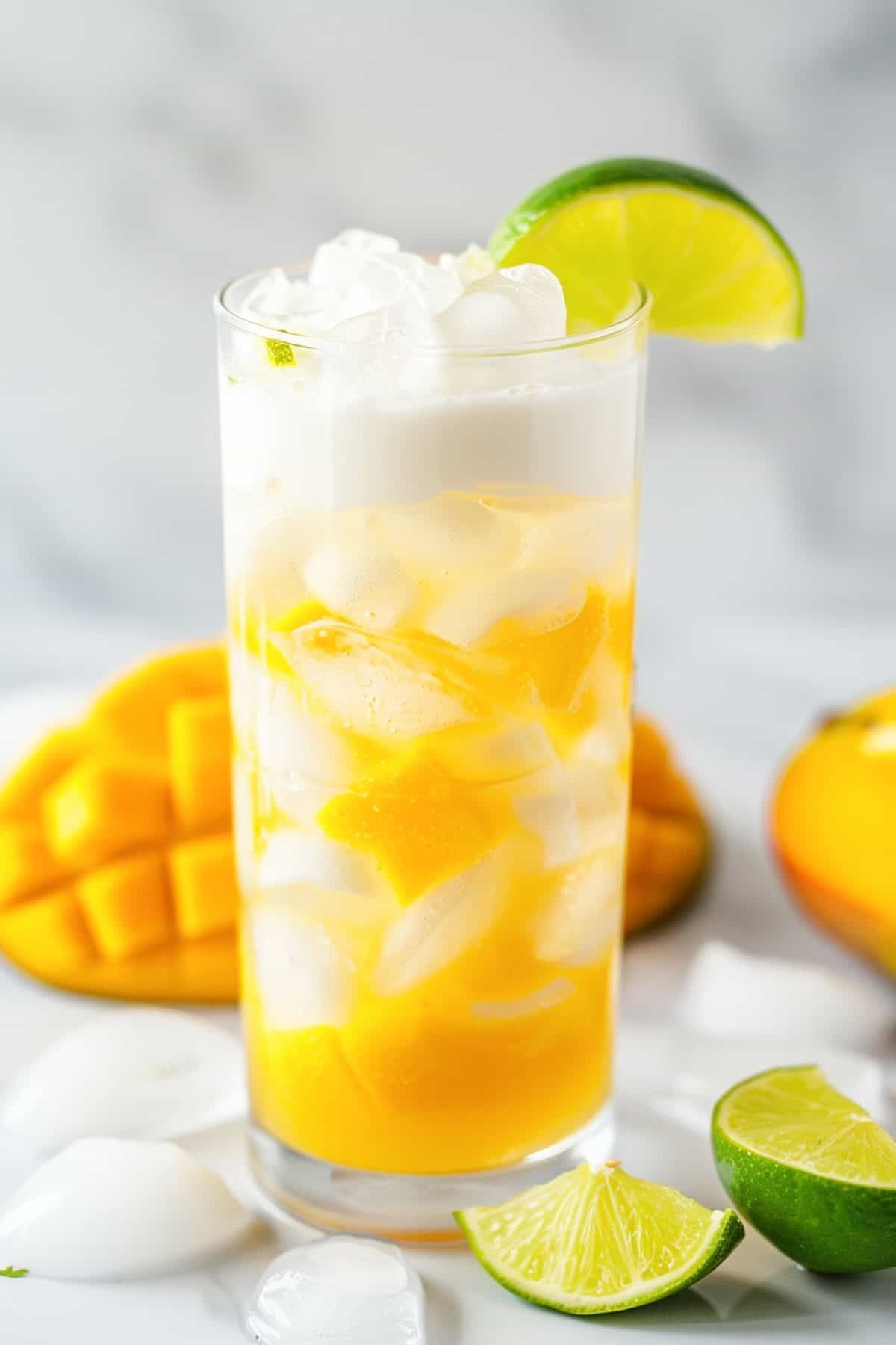 mango cream dirty soda with sprite garnished with mango and lime