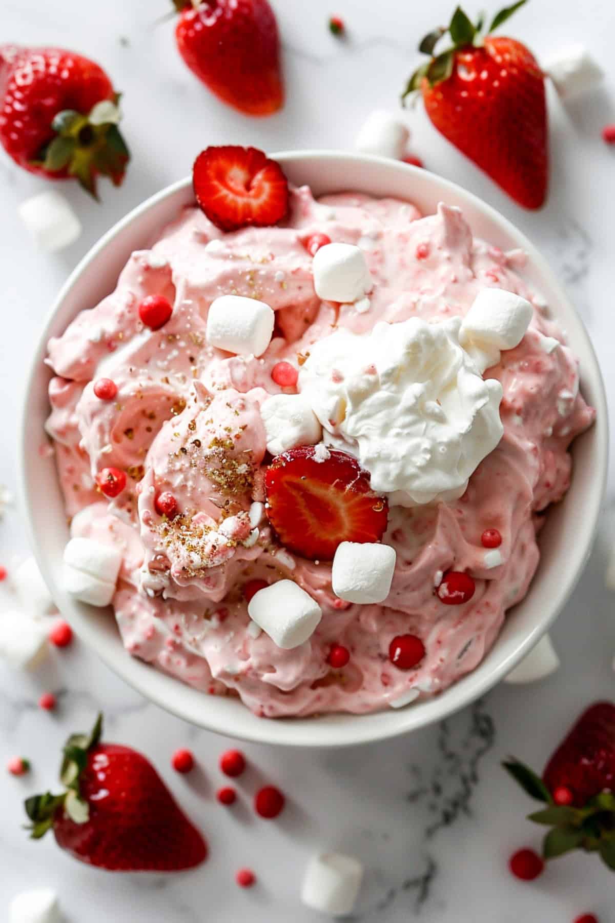 no bake strawberry fluff dessert in a white dish on a marble board