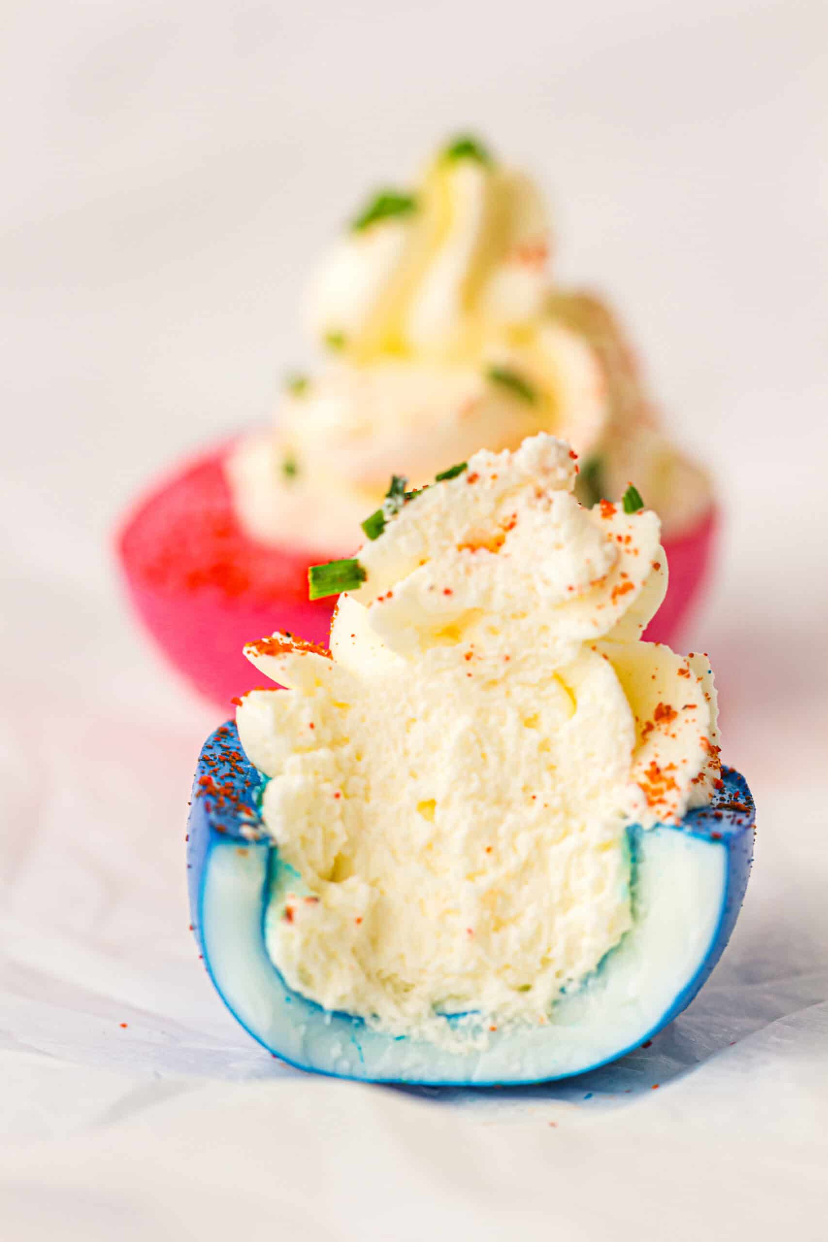 Patriotic deviled eggs cut in half.