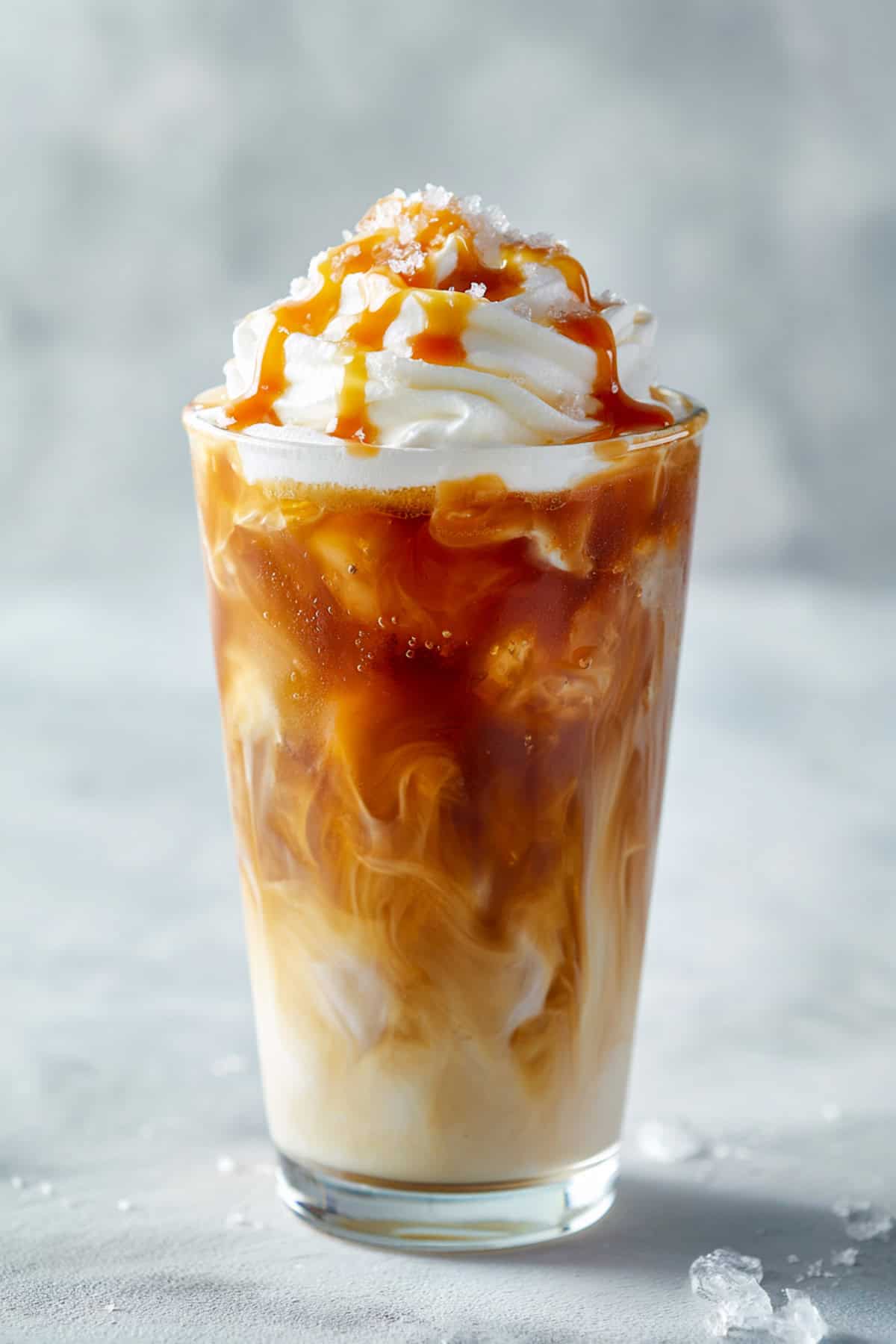 dirty caramel soda with dr pepper on a gray backdrop