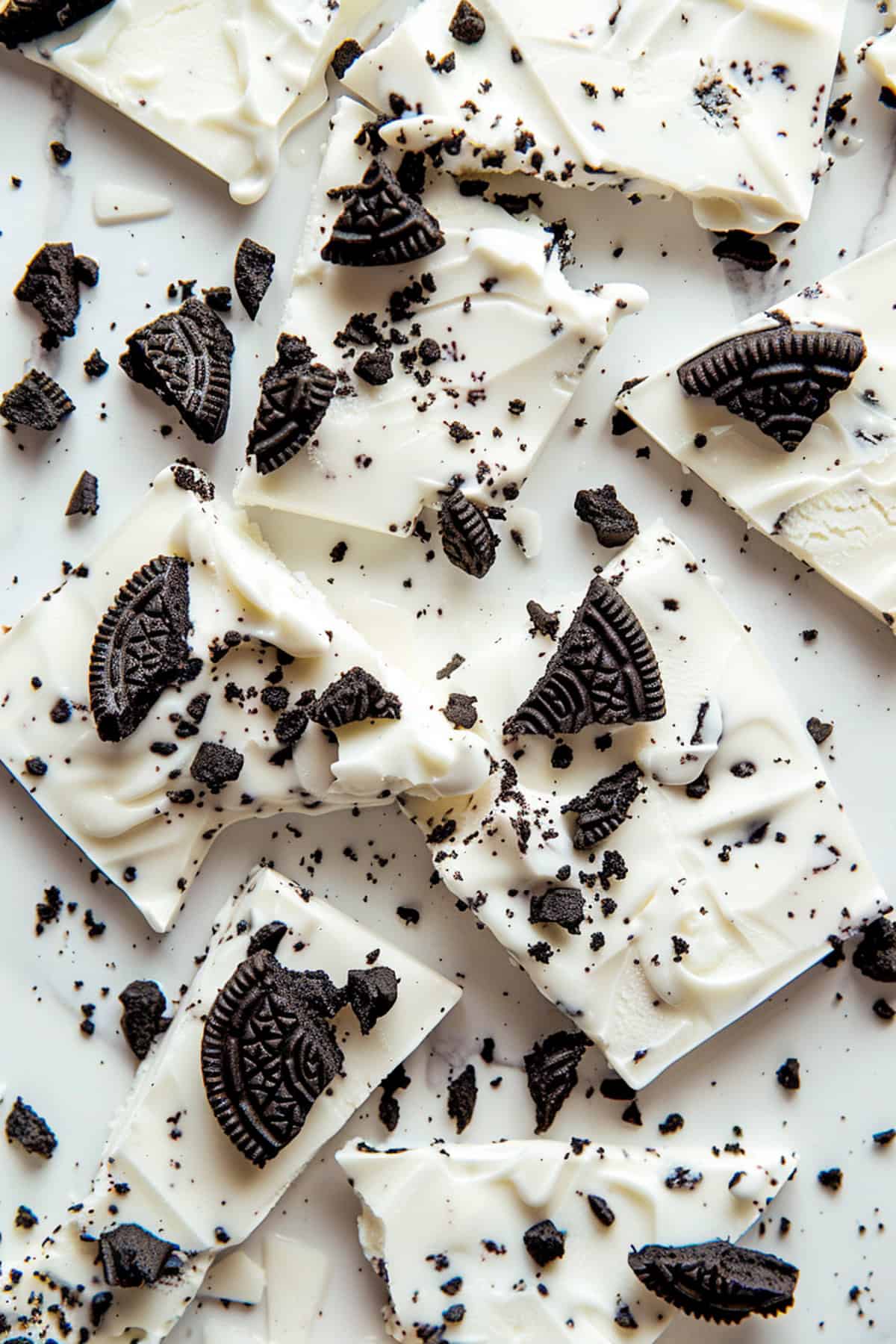 Oreo frozen yogurt bark on a marble cutting board