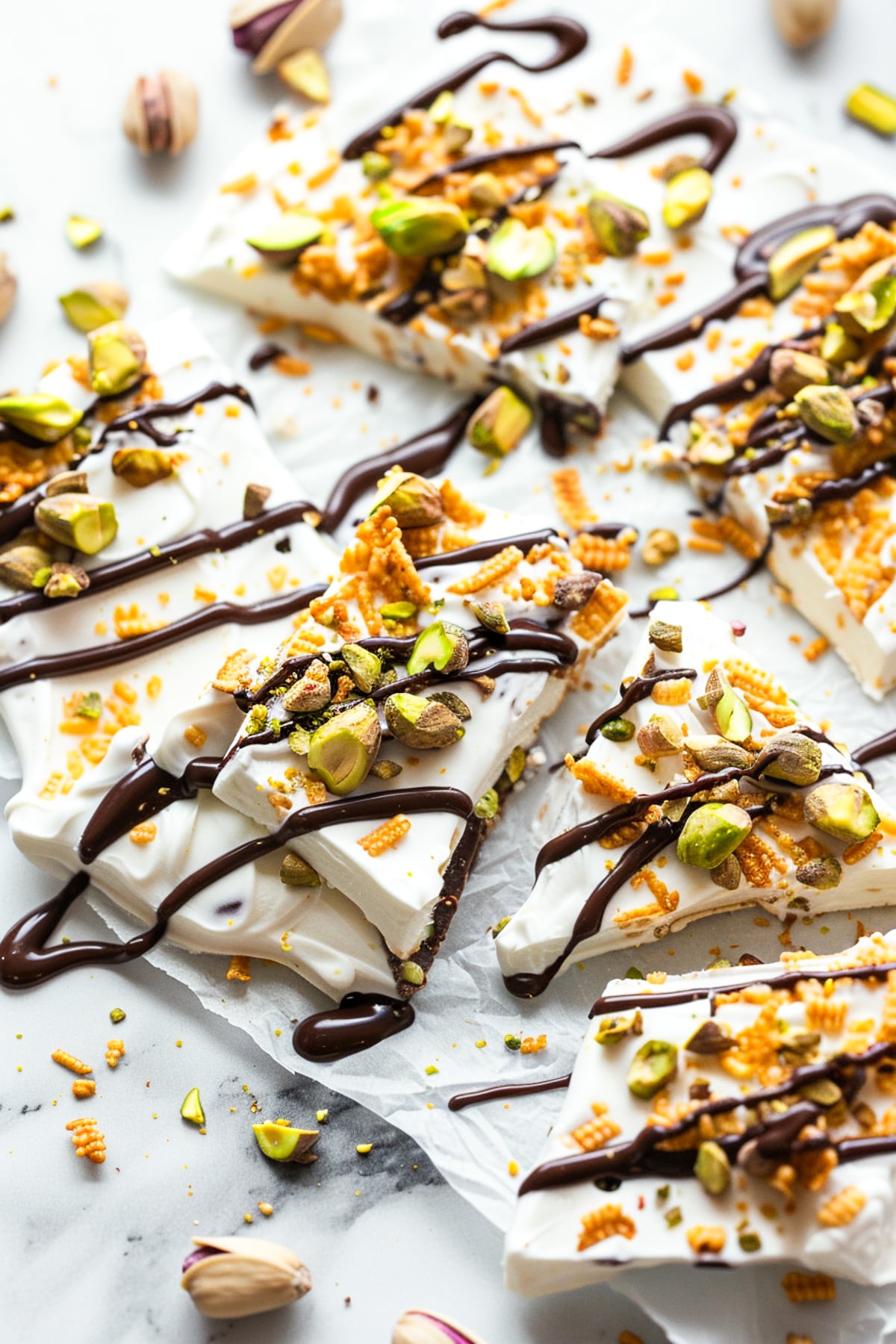 dubai chocolate frozen yogurt bark on a white cutting board