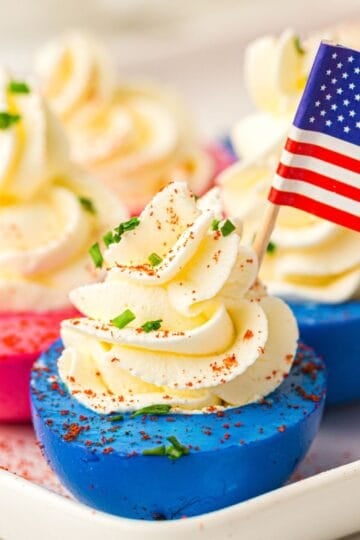 red white and blue deviled eggs with American flag.