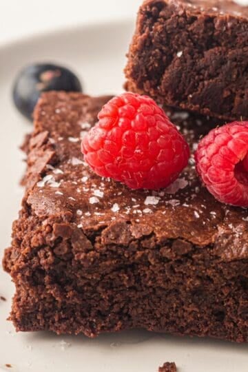 Sheet pan brownies topped with raspberries.