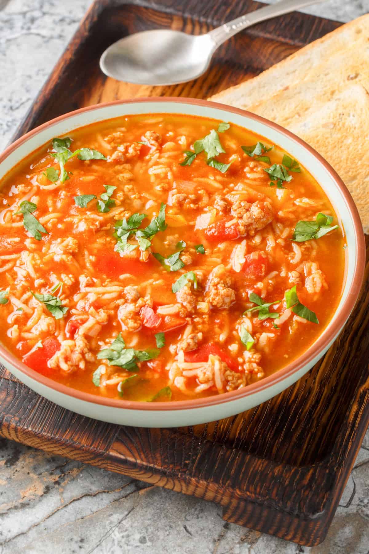 healthy slow cooker stuffed pepper soup for fall in a brown bowl