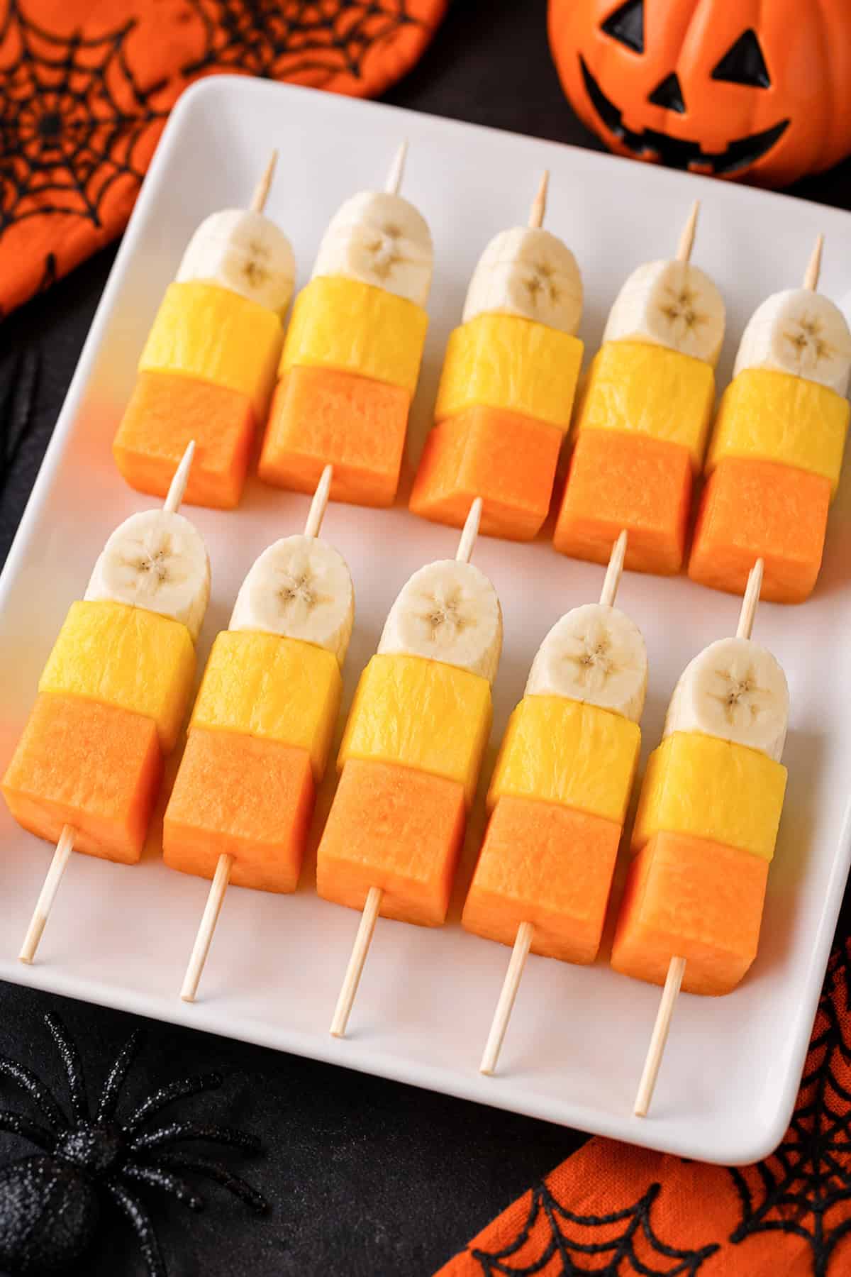 candy corn fruit sticks on a halloween background