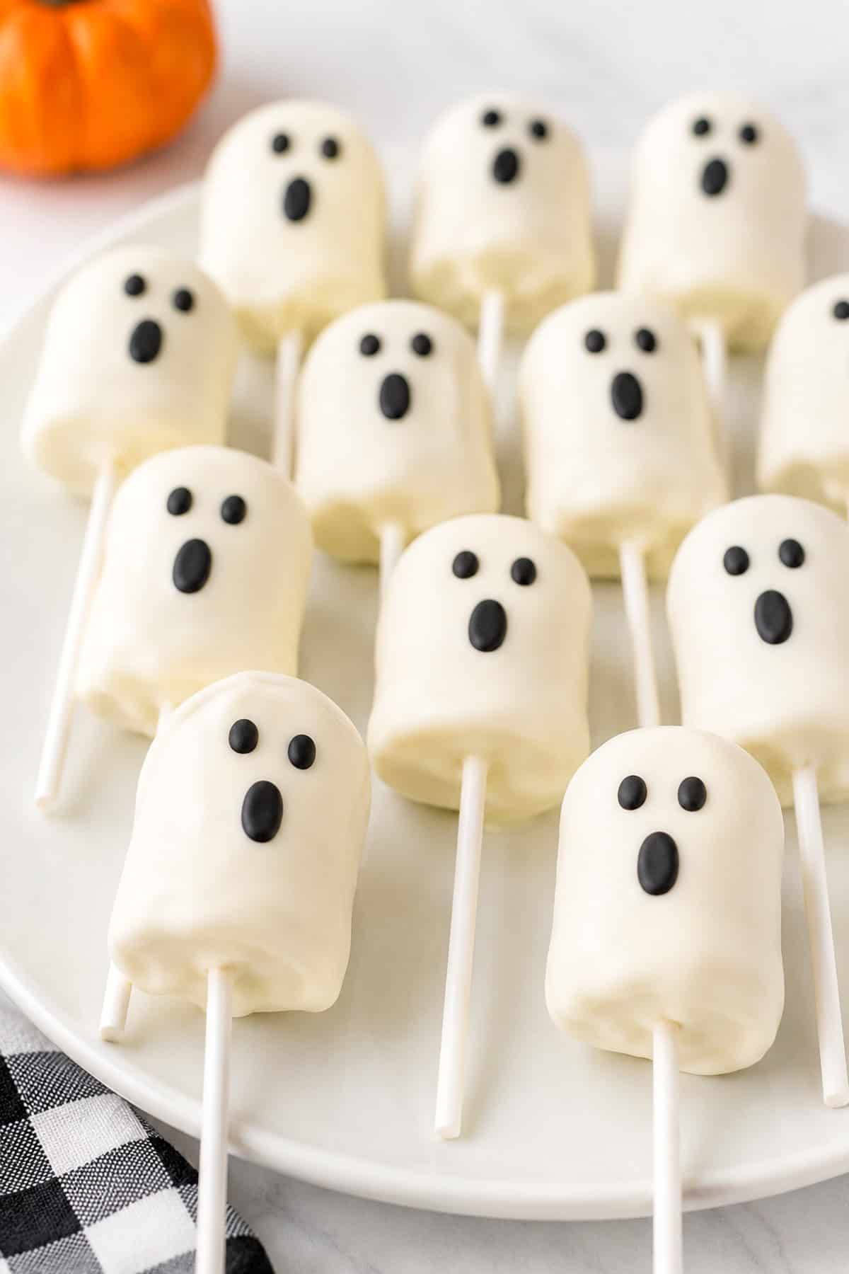 ghost cake pops on a white plate