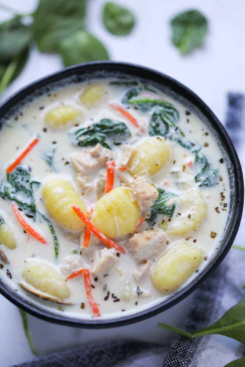 slow cooker chicken gnocchi soup in a black bowl