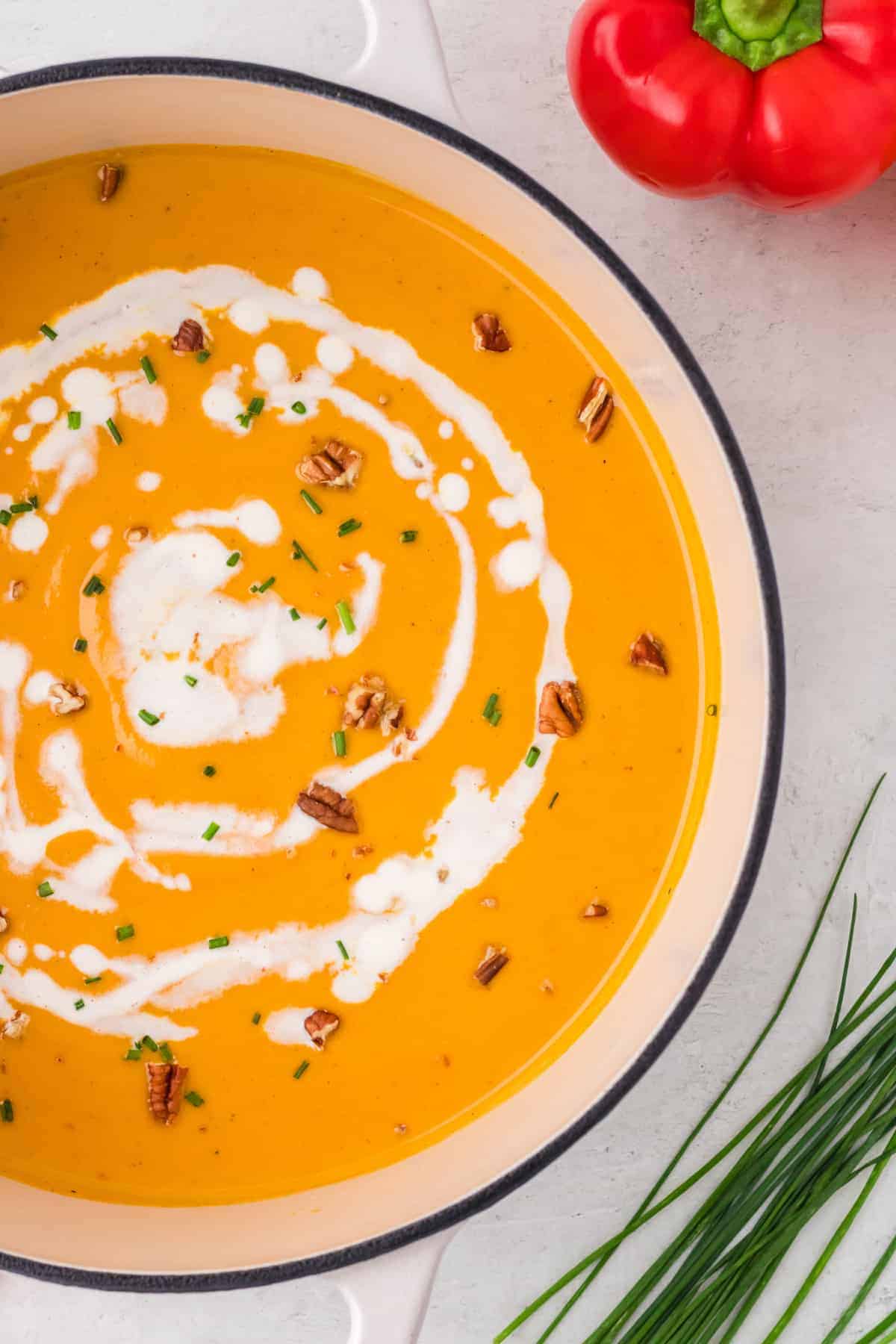 crock pot sweet potato and red pepper soup with a sour cream drizzle