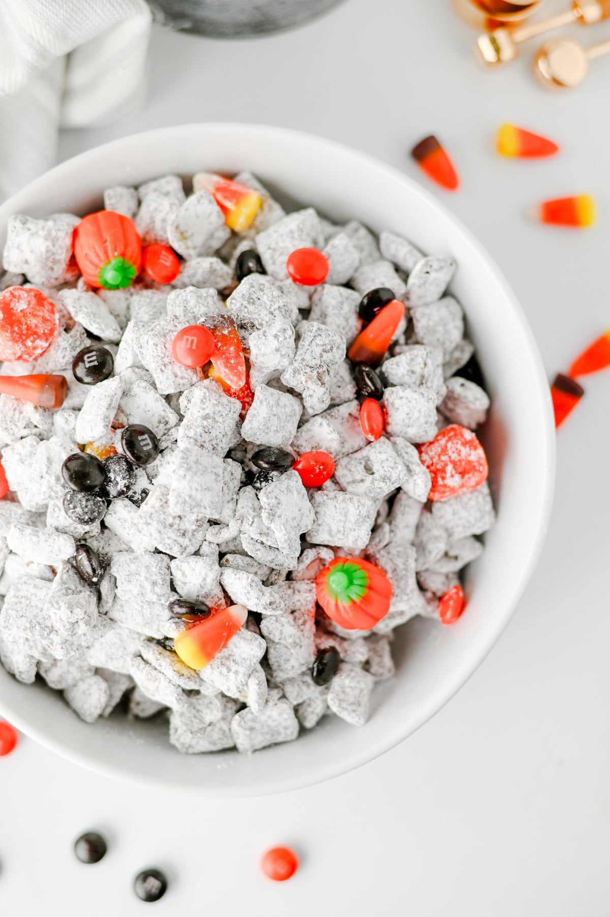 close up of halloween muddy buddy recipe in a white bowl