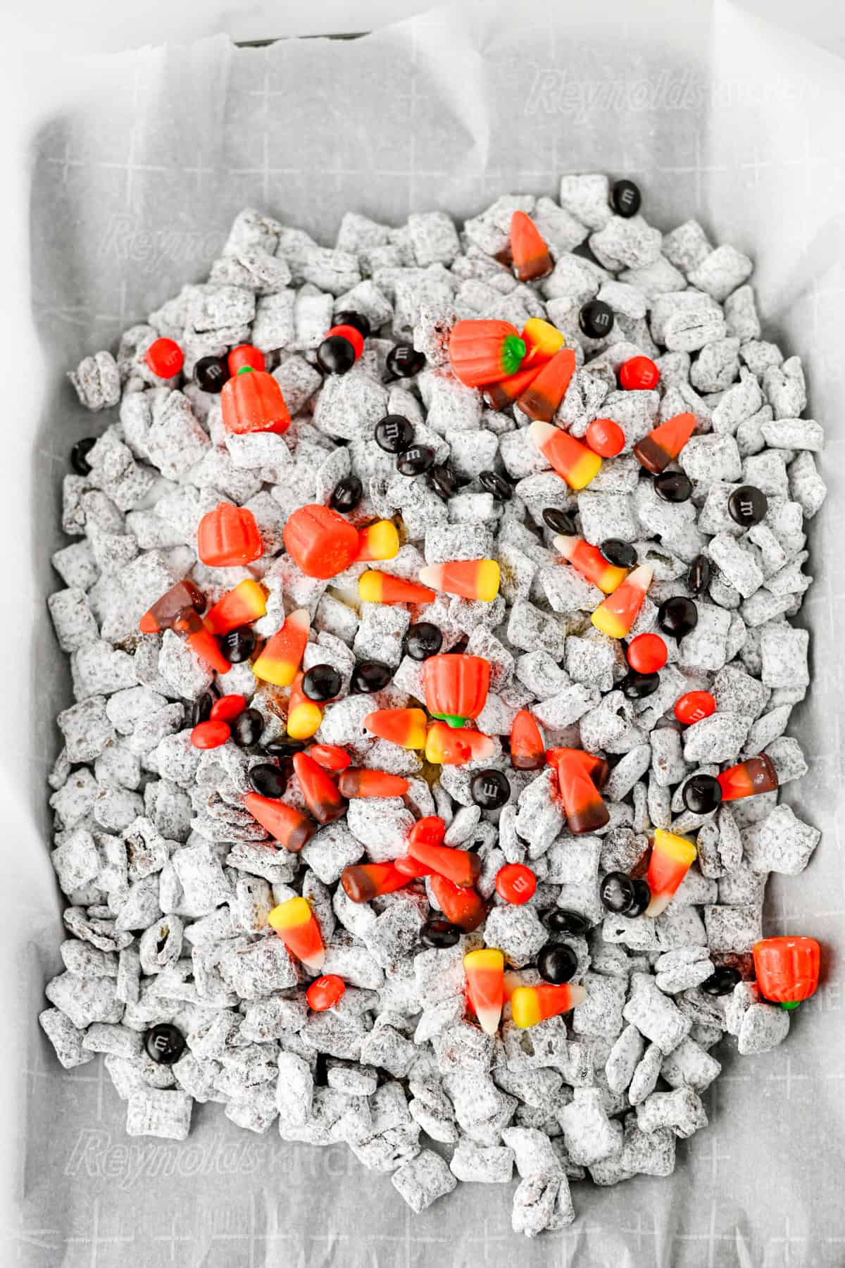 mixing in the chocolate for halloween muddy buddies