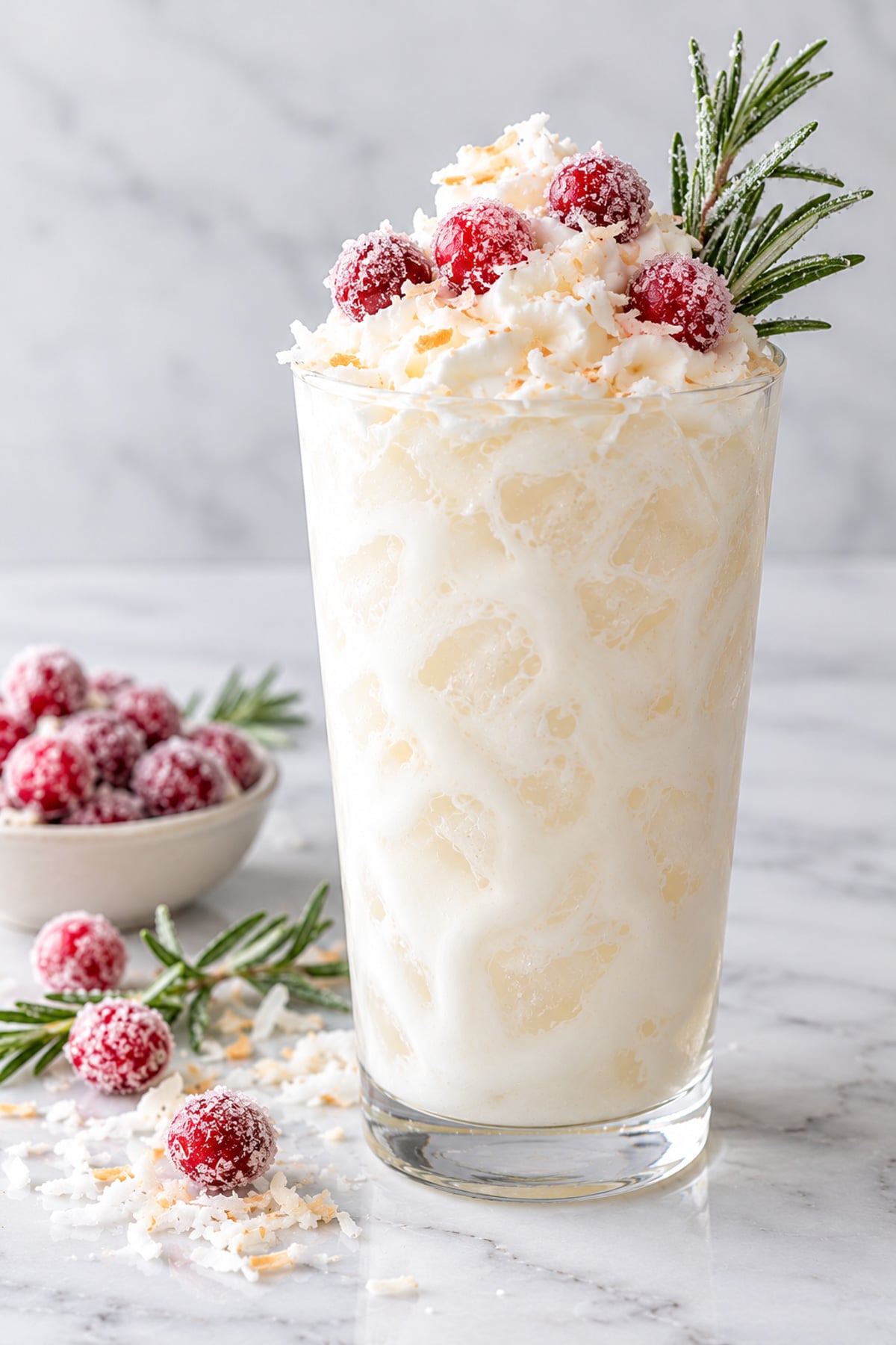 white Christmas dirty soda mocktail for the holiday season with sugared cranberries