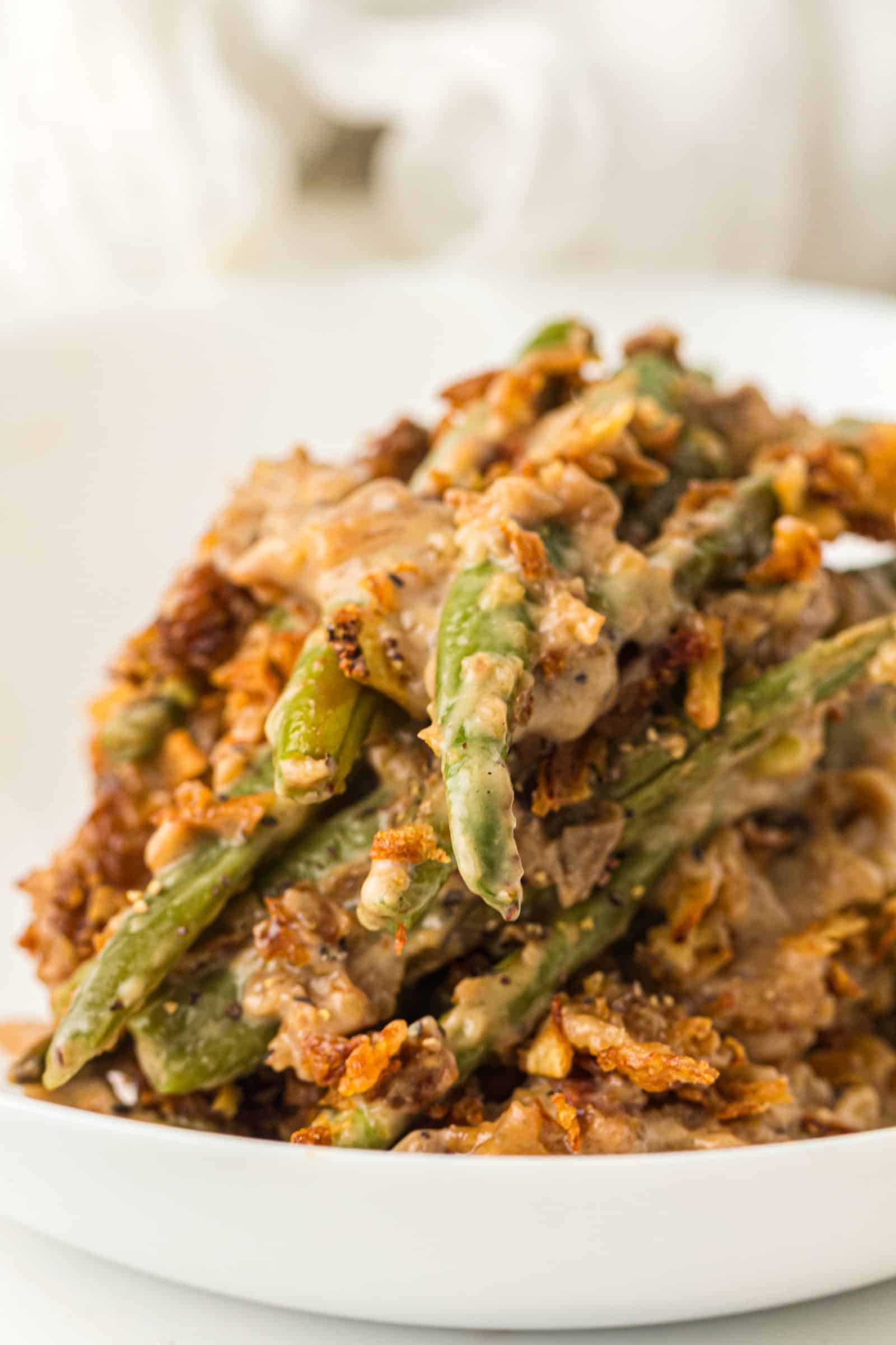 Bowl of easy green bean casserole with crispy fried onions.