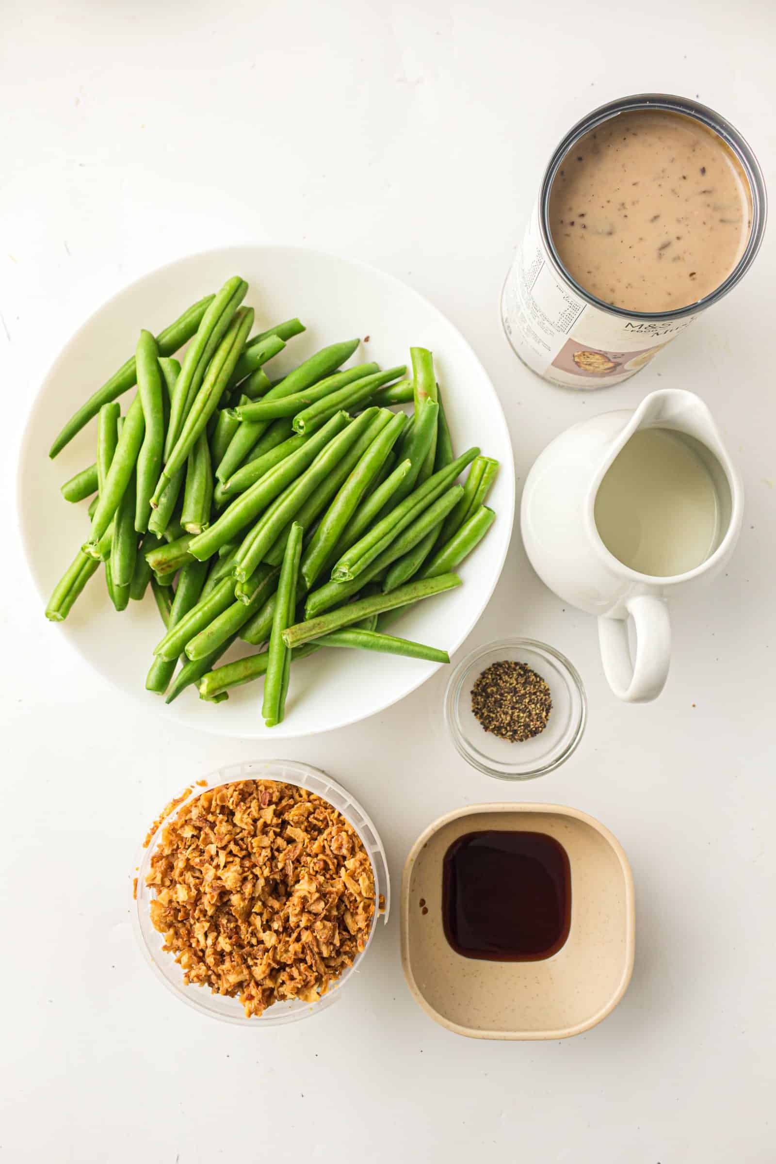 Ingredients for easy green bean casserole: green beans, cream of mushroom soup, milk, soy sauce, black pepper and French fried onions.