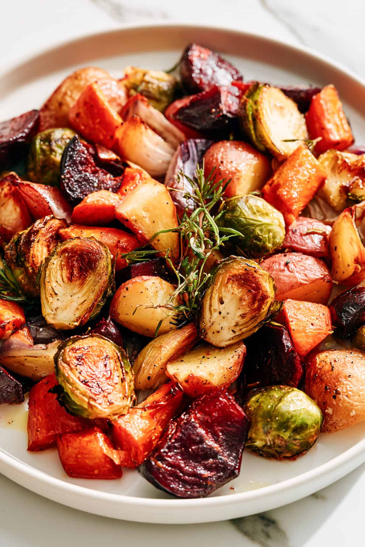 roasted fall veggies on a white dish